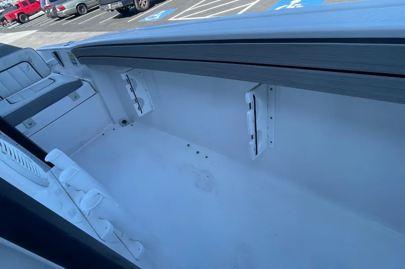 Slide: The Image of 2021 Yamaha Boats 195 FSH Sport interior, showcasing seating and storage features. - 31