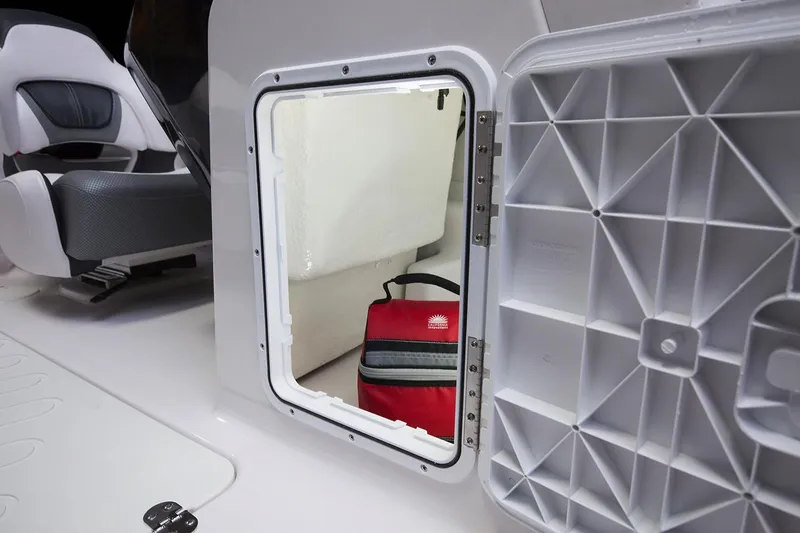 Slide: The Image of Interior of a 2019 Scarab 195 G boat, featuring sleek white and gray seating. - 14