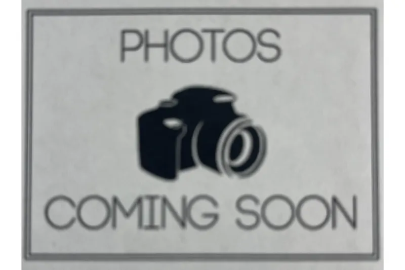 Slide: The Image of Interior seating of a 2019 Scarab 195 G boat, featuring white and black upholstery. - 17