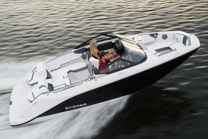Slide: The Image of 2019 Scarab 195 G boat on trailer, black and white design, parked outdoors. - 2
