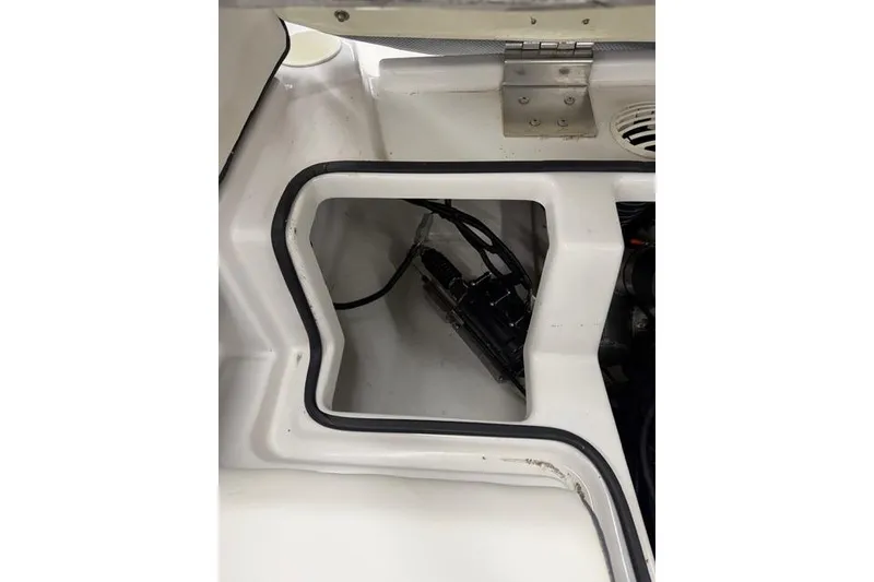 Slide: The Image of 2019 Scarab 195 G boat interior compartment with visible wiring and components. - 20