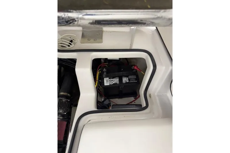 Slide: The Image of Battery compartment of a 2019 Scarab 195 G boat, showing wiring and components. - 21