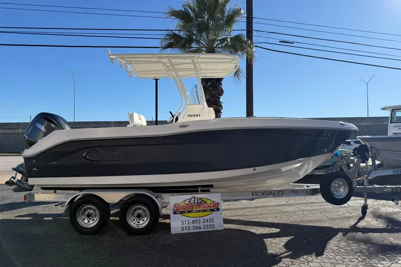 The Image of 2026 Robalo R200 Center Console boat on trailer, displayed outdoors. - 0