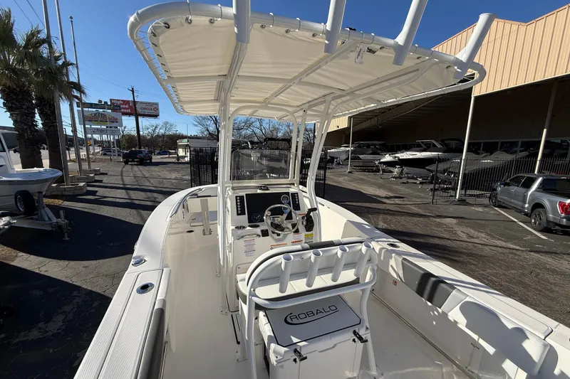 Slide: The Image of 2026 Robalo R200 Center Console boat with T-top in a dealership lot. - 15