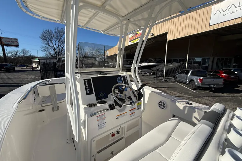 Slide: The Image of 2026 Robalo R200 Center Console boat interior with steering wheel and seating. - 16