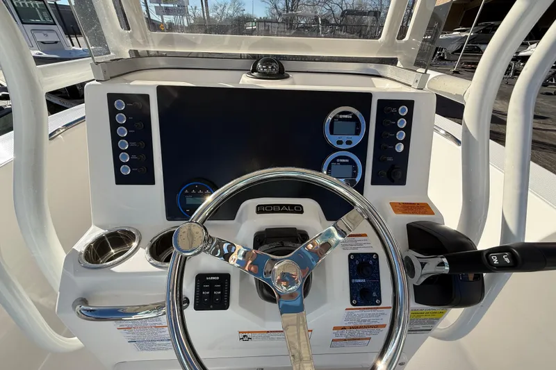 Slide: The Image of 2026 Robalo R200 Center Console boat dashboard with steering wheel and controls. - 20