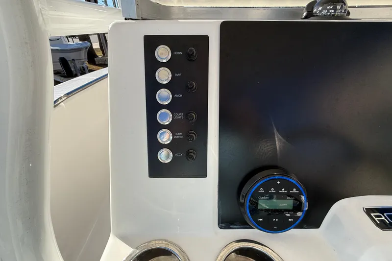 Slide: The Image of 2026 Robalo R200 Center Console dashboard with control panel and compass. - 21