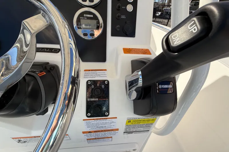 Slide: The Image of 2026 Robalo R200 Center Console boat dashboard with Yamaha controls and steering wheel. - 23