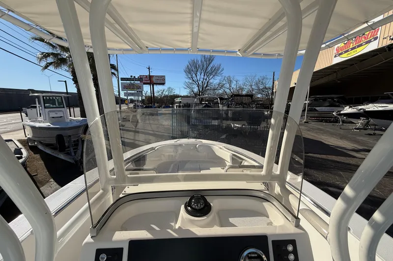 Slide: The Image of 2026 Robalo R200 Center Console boat, view from helm, parked at dealership. - 25
