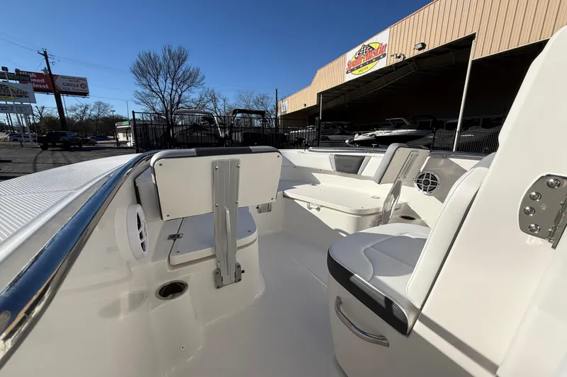 Slide: The Image of 2026 Robalo R200 Center Console boat interior with seating and storage, displayed outdoors. - 27