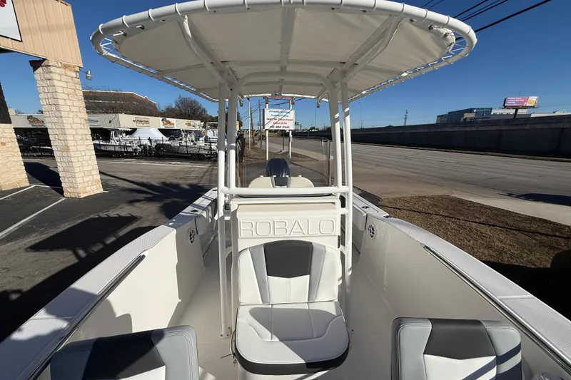 Slide: The Image of 2026 Robalo R200 Center Console boat with T-top, parked outdoors. - 28