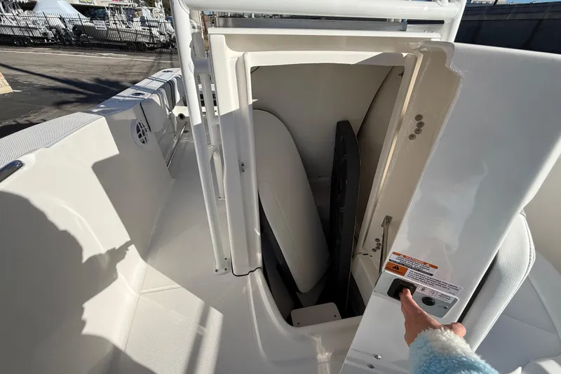Slide: The Image of 2026 Robalo R200 Center Console boat storage compartment with open door. - 29