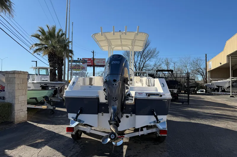 Slide: The Image of 2026 Robalo R200 Center Console boat with outboard motor, parked outdoors. - 3