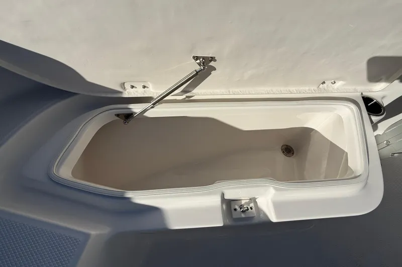 Slide: The Image of Open storage compartment on 2026 Robalo R200 Center Console boat. - 33