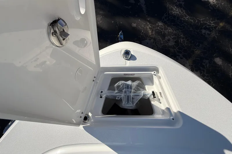 Slide: The Image of 2026 Robalo R200 Center Console boat anchor storage compartment open. - 35