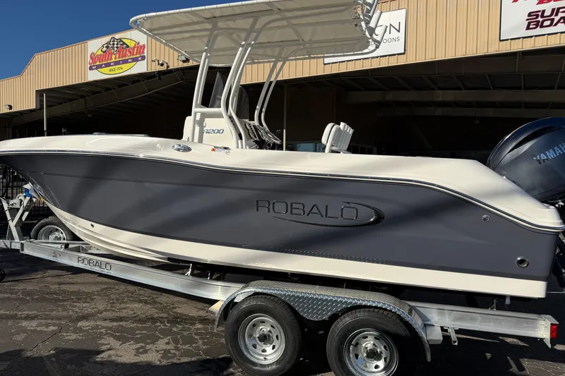 Slide: The Image of 2026 Robalo R200 Center Console boat on trailer, displayed outdoors. - 5