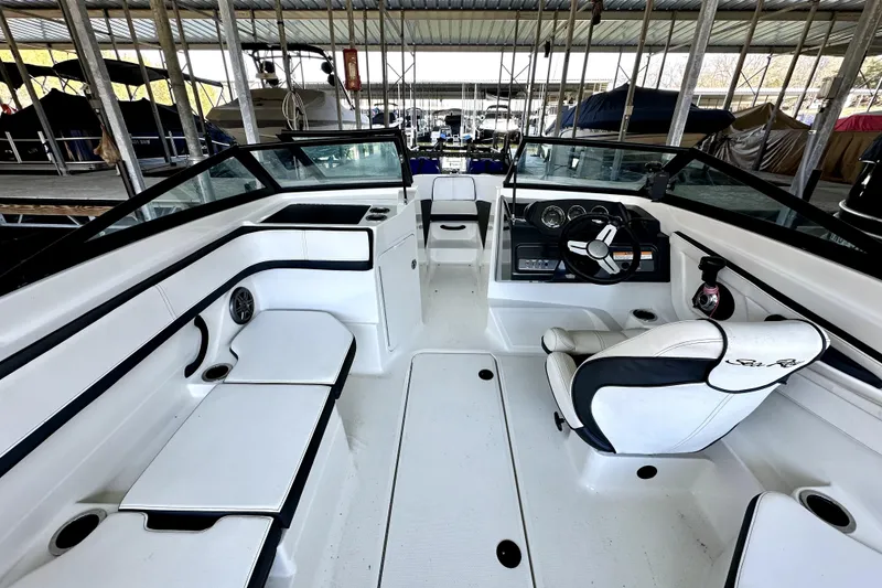 Slide: The Image of 2015 Sea Ray 21 SPX OB boat interior with white seating and steering console. - 4