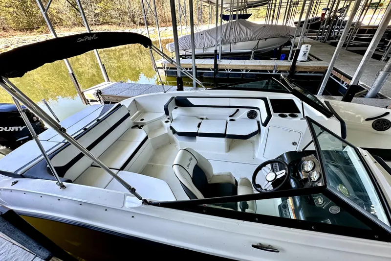 Slide: The Image of 2015 Sea Ray 21 SPX OB boat with spacious seating, docked under a canopy. - 8