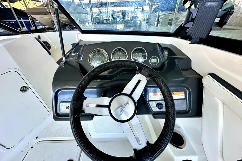 Slide: The Image of 2015 Sea Ray 21 SPX OB boat dashboard with steering wheel and gauges. - 9