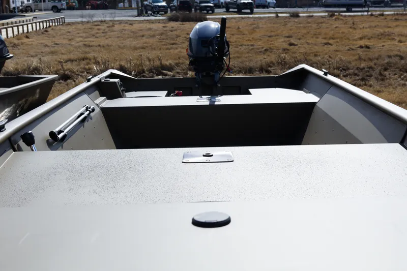 Slide: The Image of 2026 G3 Gator Tough 15 FL boat with outboard motor in grassy area. - 4