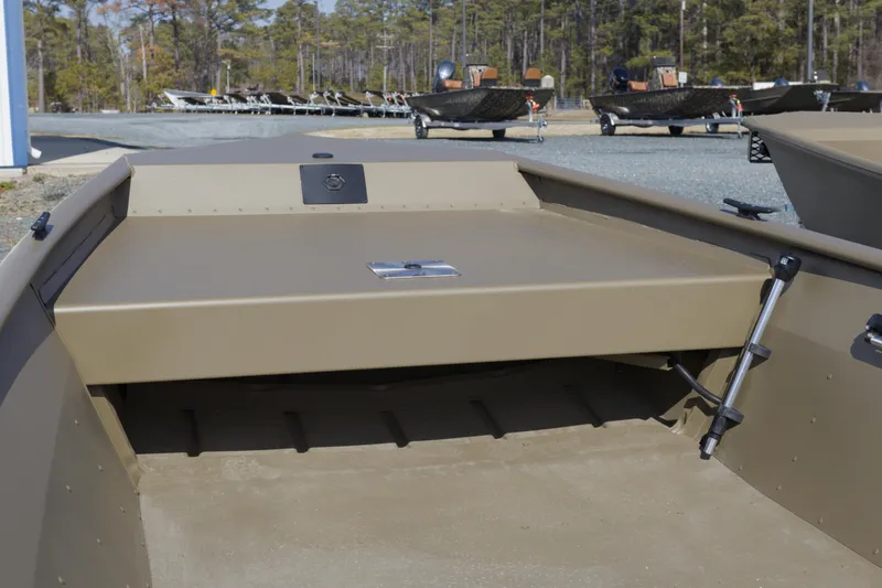 Slide: The Image of 2026 G3 Gator Tough 15 FL boat interior with storage compartment, parked outdoors. - 5