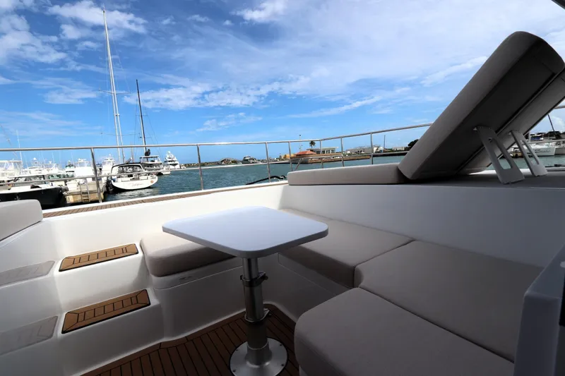 Slide: The Image of Luxurious seating area on 2025 Two Oceans 55 yacht, overlooking marina with blue sky. - 16