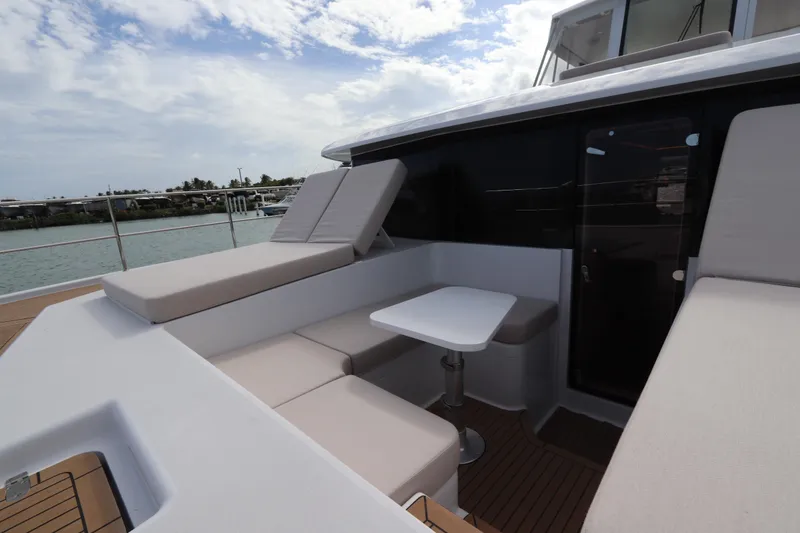 Slide: The Image of Luxurious seating area on 2025 Two Oceans 55 yacht, featuring comfortable cushions and a sleek table. - 17