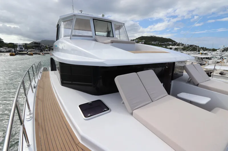 Slide: The Image of Luxury 2025 Two Oceans 55 yacht with sun loungers, docked in a marina. - 20