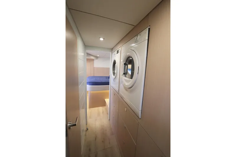 Slide: The Image of Laundry area in 2025 Two Oceans 55 yacht with stacked washer and dryer. - 23