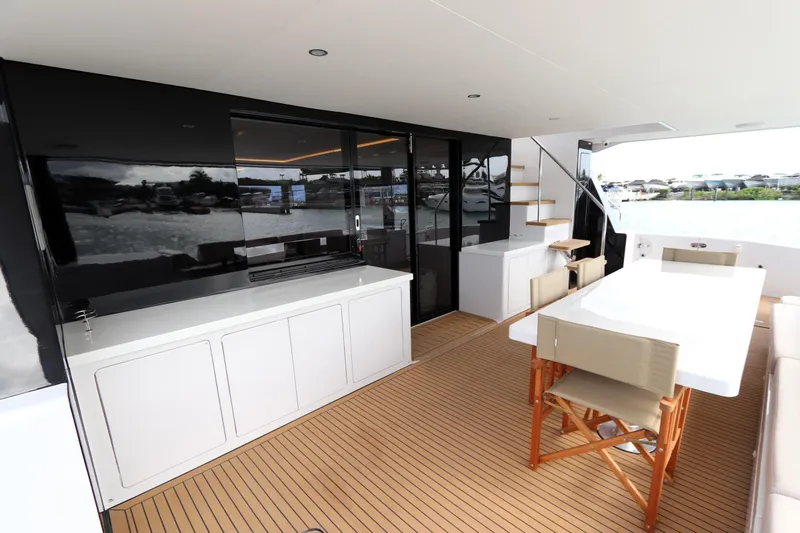 Slide: The Image of Luxurious 2025 Two Oceans 55 yacht deck with dining area and sleek design. - 3