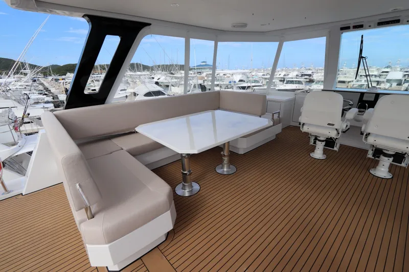 Slide: The Image of Luxurious 2025 Two Oceans 55 yacht interior with seating and helm chairs, docked at marina. - 36