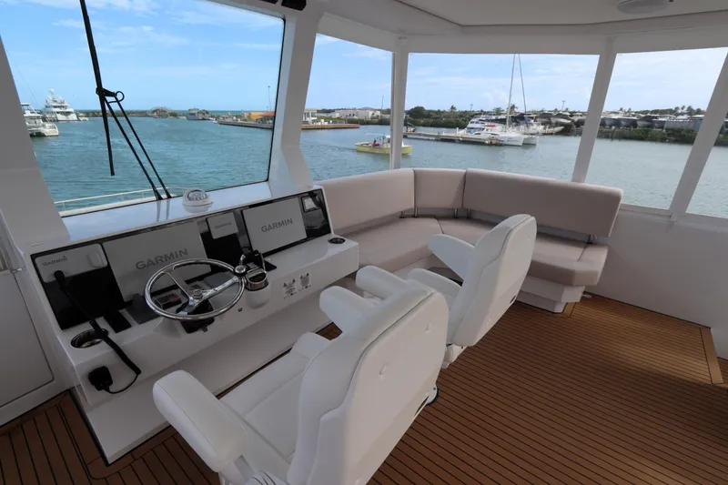 Slide: The Image of Luxurious 2025 Two Oceans 55 yacht interior with helm, seating, and scenic marina view. - 38