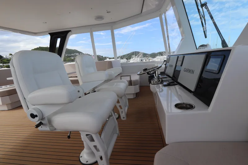 Slide: The Image of Luxurious helm of 2025 Two Oceans 55 yacht with white seating and advanced navigation systems. - 39