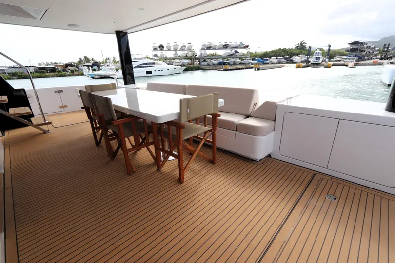 Slide: The Image of Luxurious deck of 2025 Two Oceans 55 yacht with elegant seating and scenic marina view. - 4