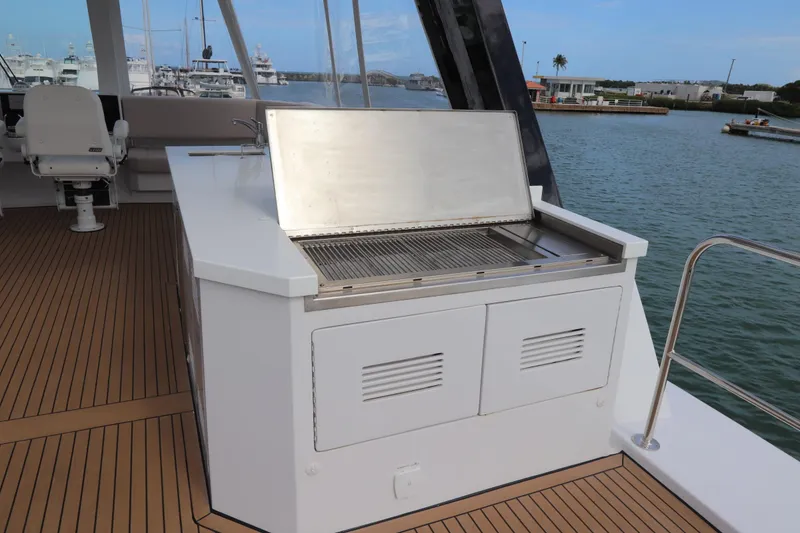 Slide: The Image of Outdoor grill on Two Oceans 55 yacht, 2025 model, with scenic marina view. - 43