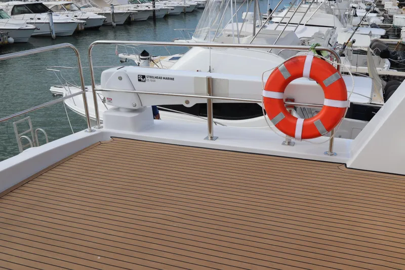 Slide: The Image of Luxury yacht deck with lifebuoy, featuring Two Oceans 55 model, 2025. - 44