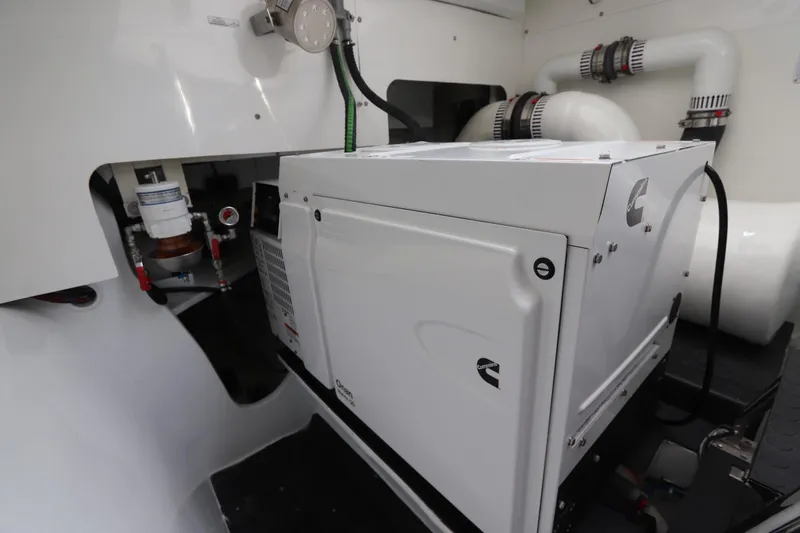 Slide: The Image of Engine room of 2025 Two Oceans 55 yacht featuring Cummins generator and piping system. - 49