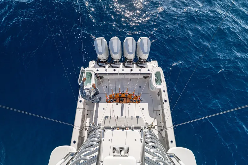 Slide: The Image of 2026 SeaVee 420Z boat with four engines on open ocean, aerial view. - 20