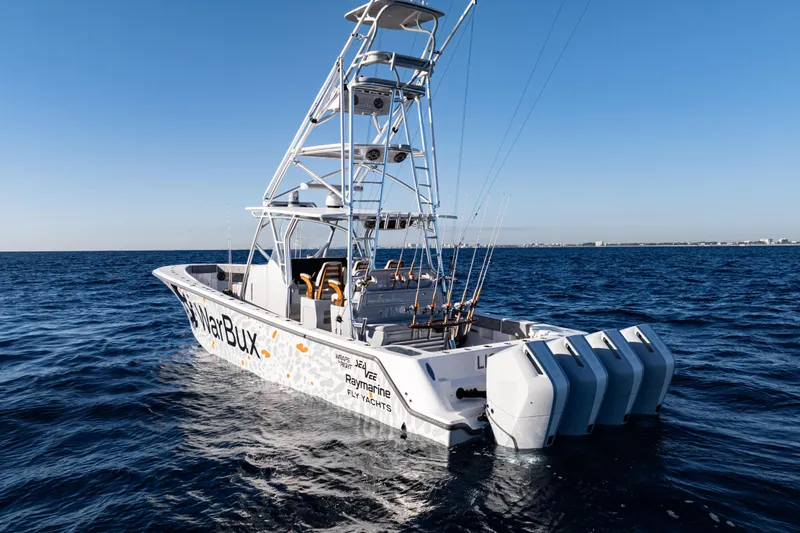 Slide: The Image of 2026 SeaVee 420Z boat with multiple engines cruising on open water. - 3