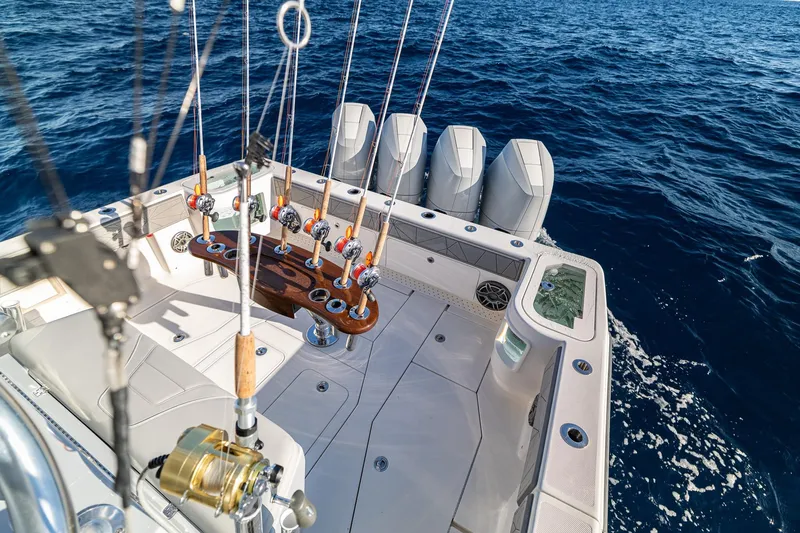 Slide: The Image of 2026 SeaVee 420Z fishing boat with rod holders, ocean view, and powerful engines. - 34