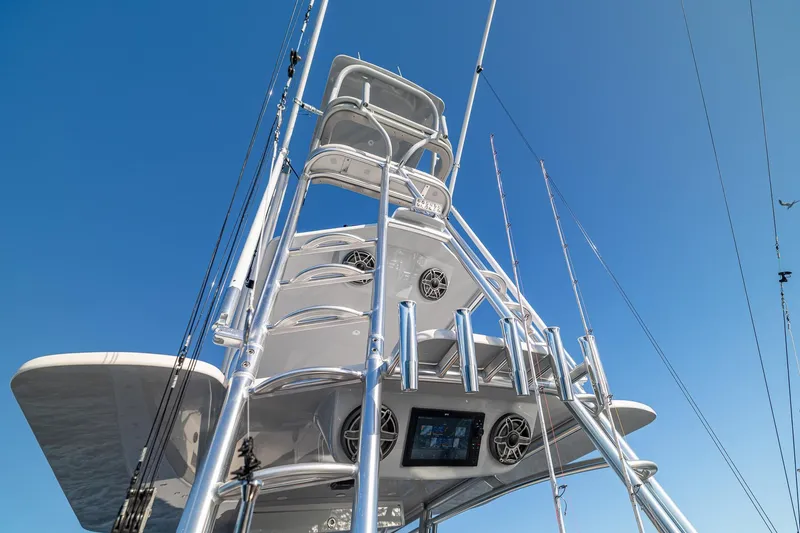 Slide: The Image of 2026 SeaVee 420Z boat tower with fishing rods against clear blue sky. - 43