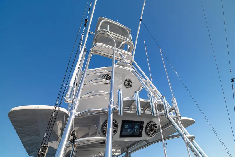 Slide: The Image of 2026 SeaVee 420Z boat tower with rods against clear blue sky. - 44