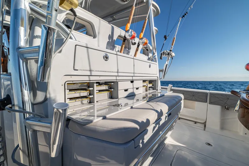 Slide: The Image of 2026 SeaVee 420Z boat interior with fishing rods and seating on open water. - 47