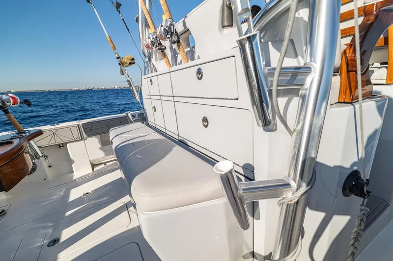 Slide: The Image of 2026 SeaVee 420Z fishing boat with rods, ocean view, and seating area. - 48