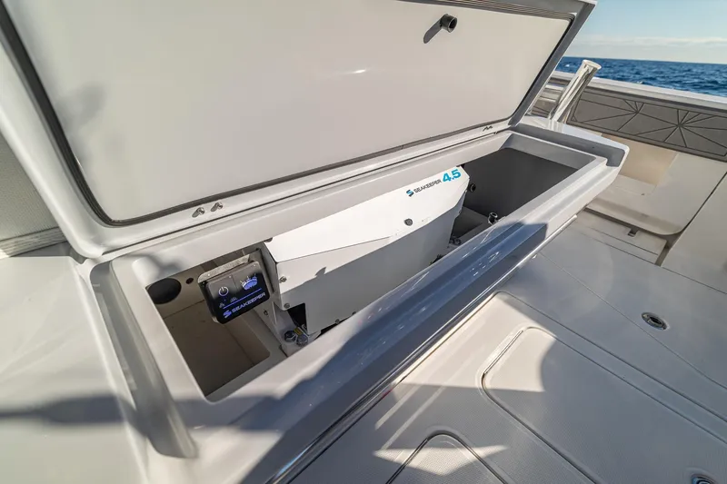 Slide: The Image of 2026 SeaVee 420Z boat interior with luxurious seating and fishing rods on a sunny day. - 50