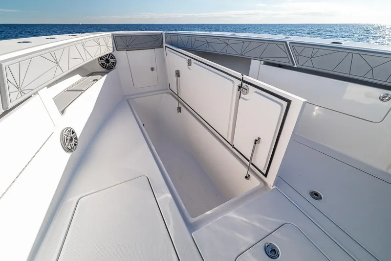 Slide: The Image of 2026 SeaVee 420Z boat interior with open storage compartment, ocean view in background. - 55