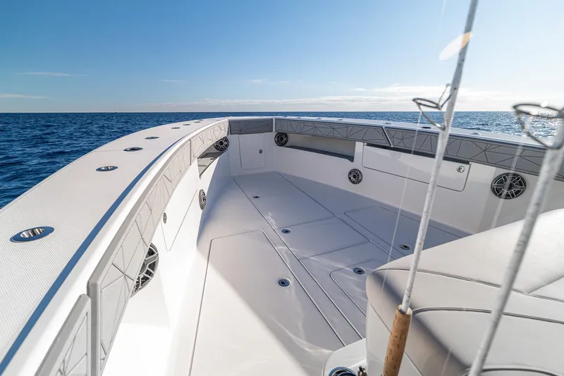 Slide: The Image of 2026 SeaVee 420Z boat deck with fishing rods, ocean view, and clear sky. - 60