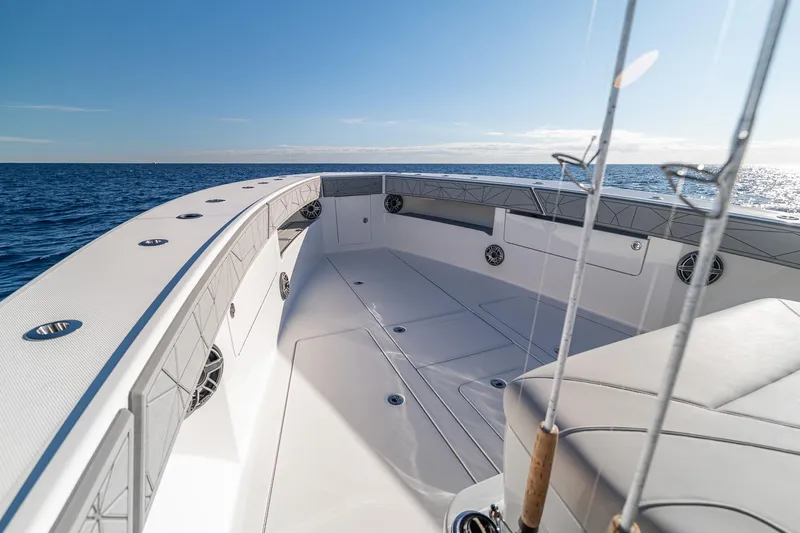 Slide: The Image of 2026 SeaVee 420Z boat deck with fishing rods on open ocean. - 61