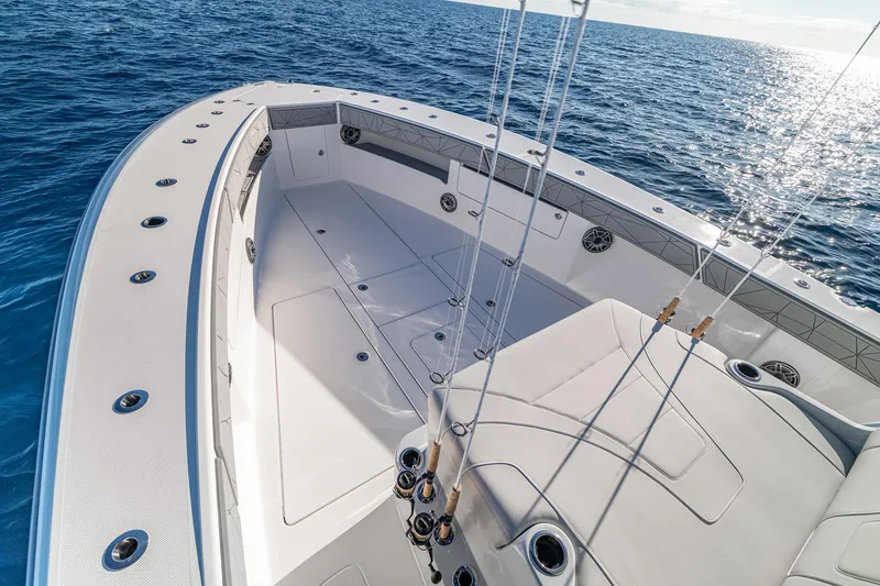 Slide: The Image of 2026 SeaVee 420Z boat on open ocean, clear sky, fishing rods visible. - 62