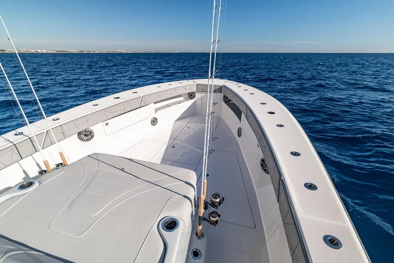 Slide: The Image of 2026 SeaVee 420Z boat deck with fishing rods, ocean view, and clear blue sky. - 65